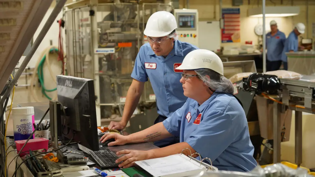 Post Consumer Brands employees working at a computer