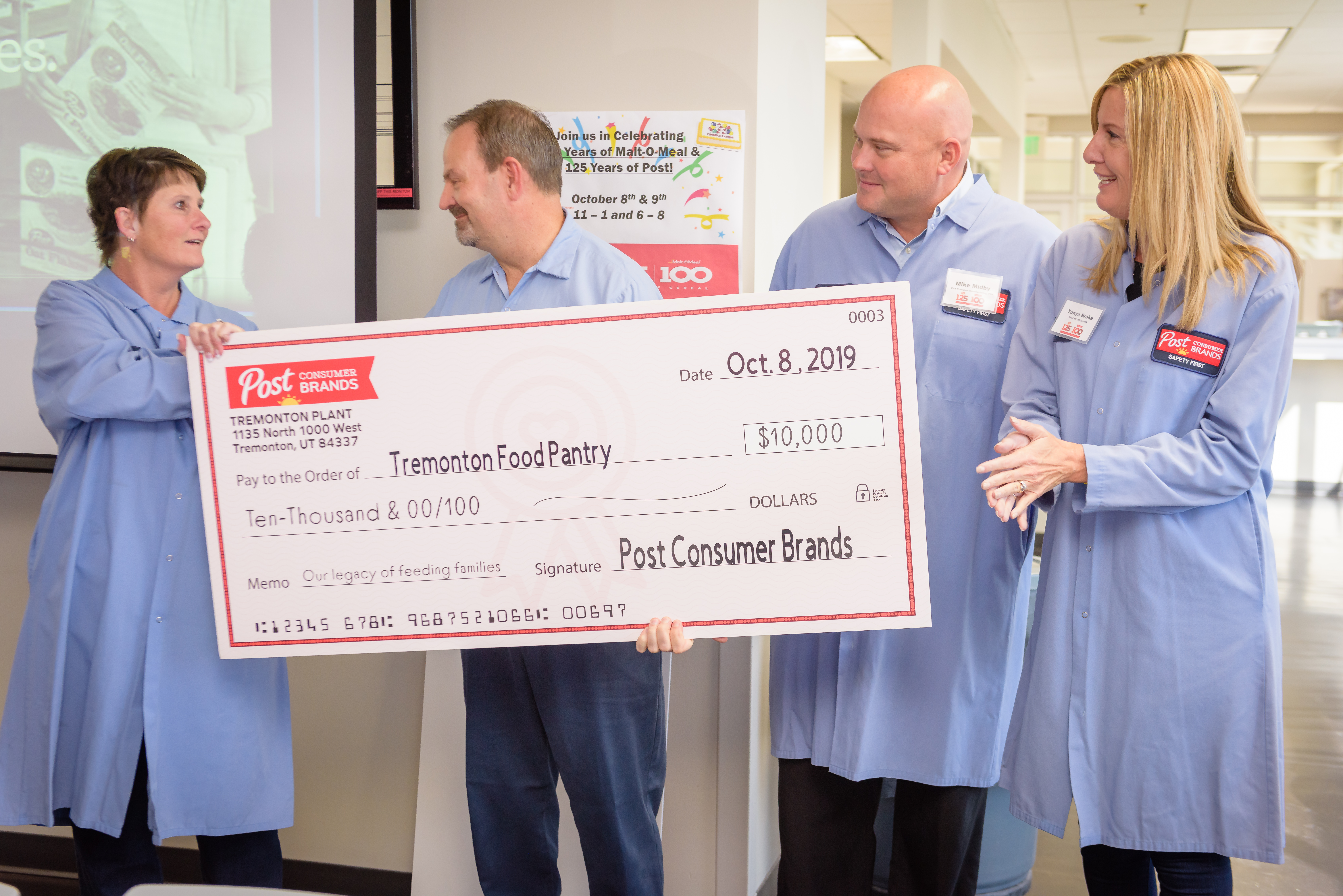 Group standing behind donation check