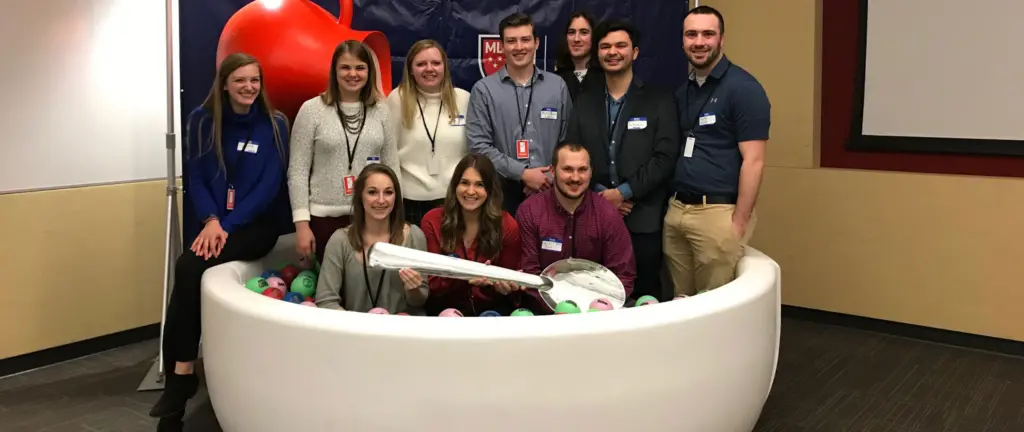 Former Post Cereal Interns standing in a giant cereal bowl