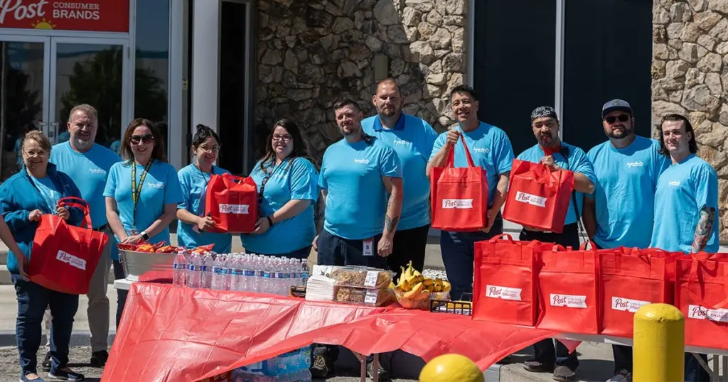 Post employees donating bags of food and supplies to local communities