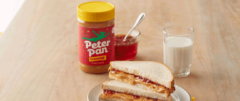Peter Pan peanut butter next to a PB&J sandwich