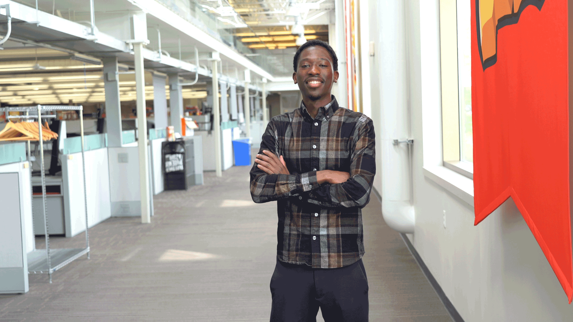 A Post employee stands in an office.