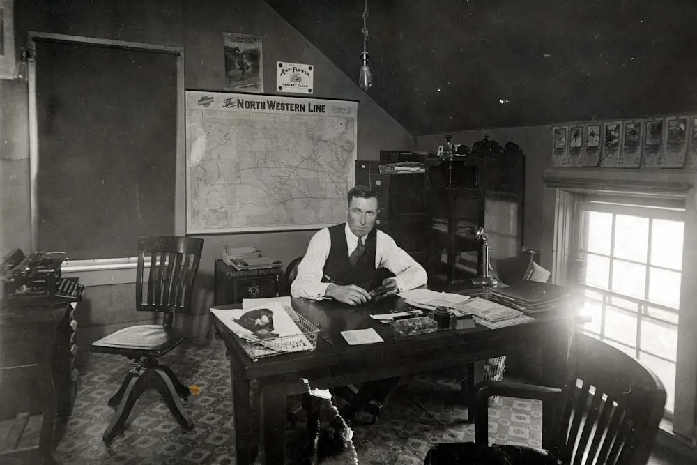 John Campbell sitting at a desk
