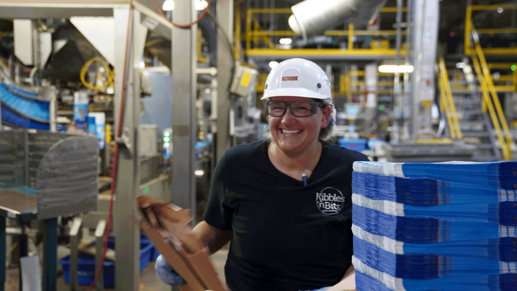 A woman in a hardhat works in a Post facility