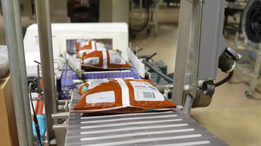 Packages of cereal on a conveyor belt.