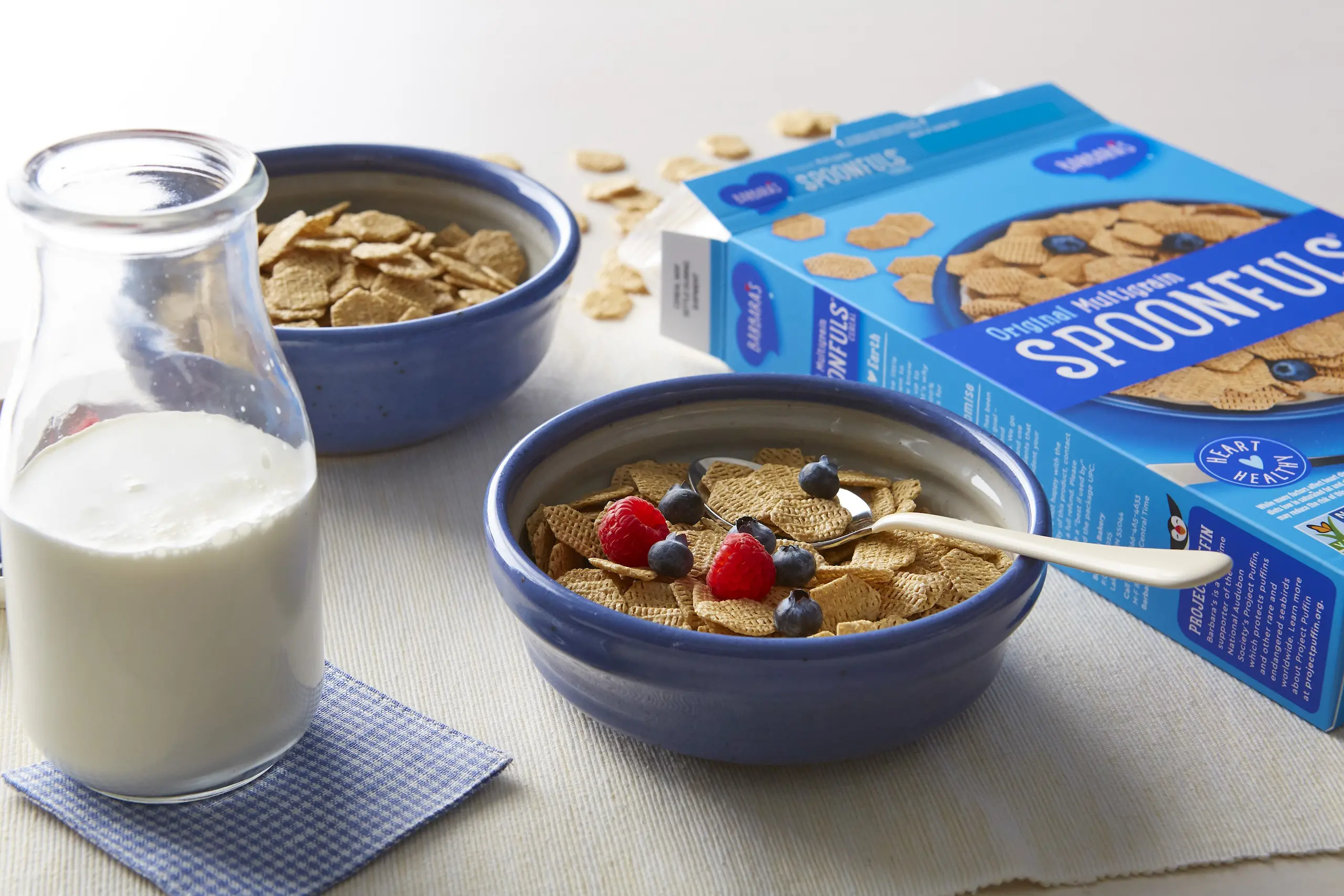 Barbara's Original Multigrain Spoonfuls cereal box and bowl next to glass of milk