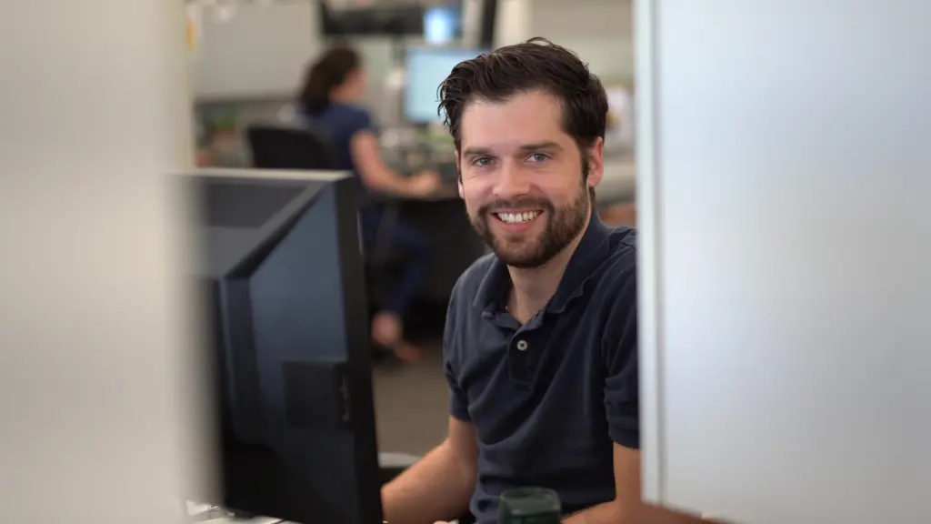 A man works at a computer in an office