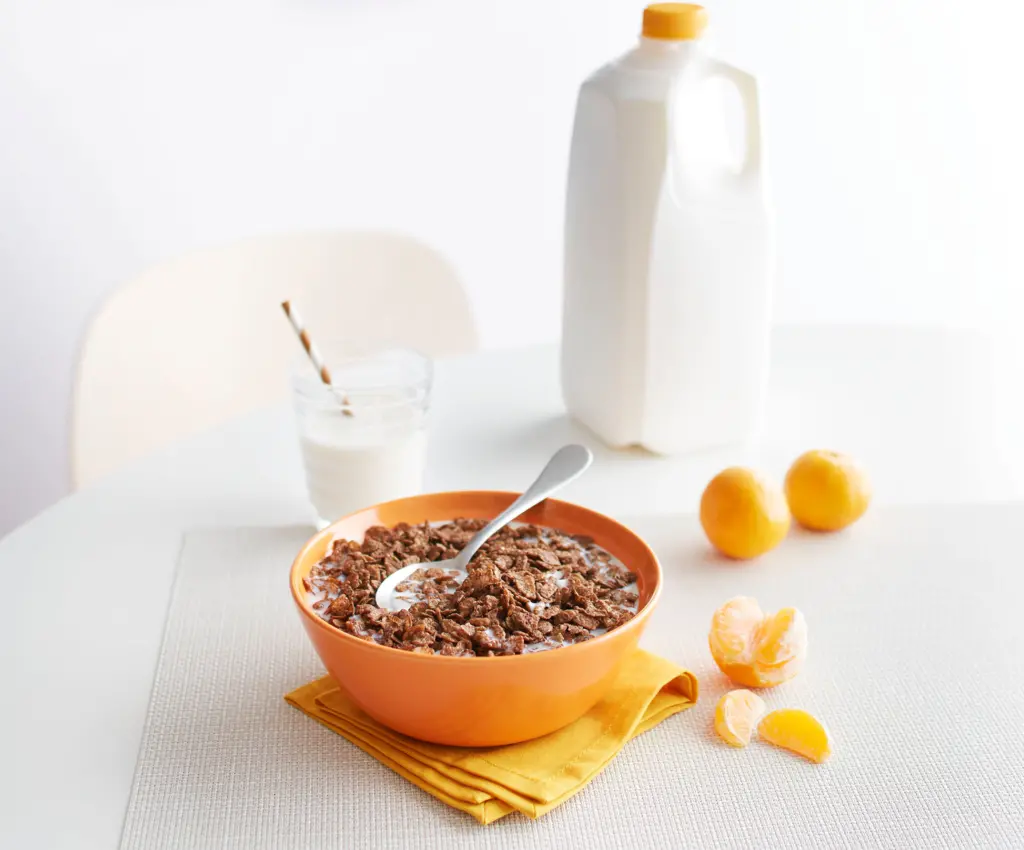 Cocoa PEBBLES cereal in a bowl on top of a kitchen table