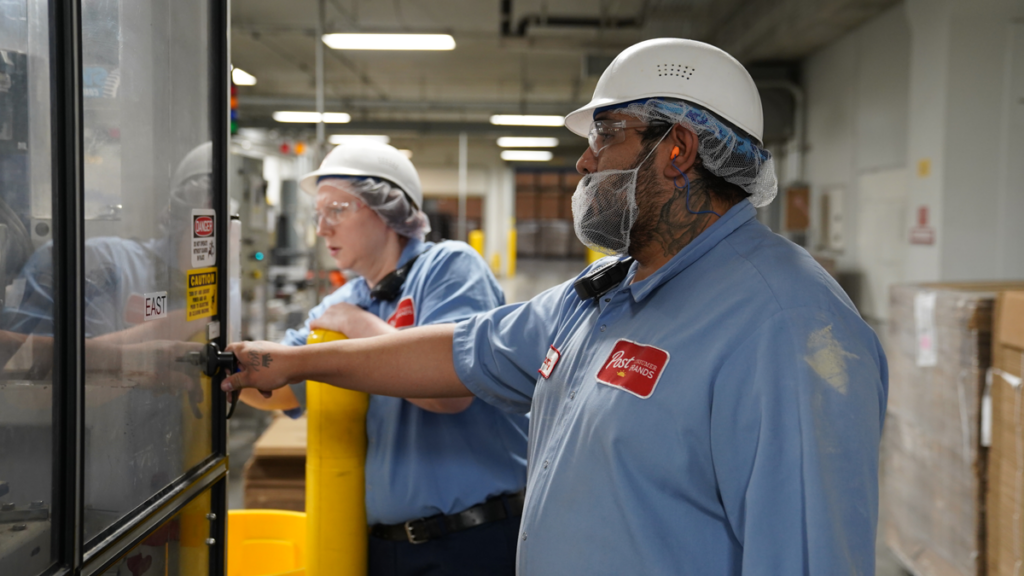 Two Post employees working in a facility