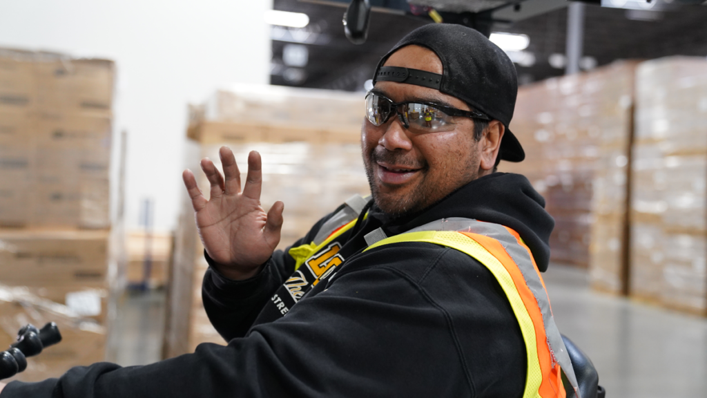 A Post employee waves at the camera.