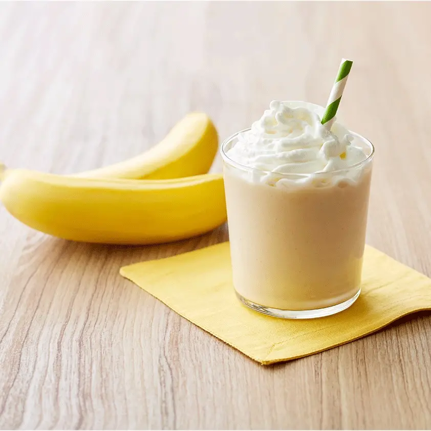 peanut butter banana smoothie next to a banana